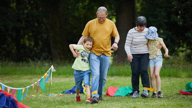 Family taking part in a three legged race